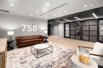 a view of the lobby of elevate 758 with a leather couch and coffee table